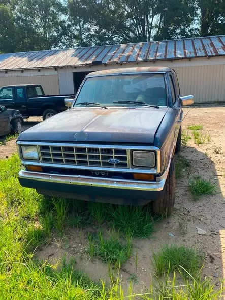 Front view of a classic Ford at the Greenwood salvage yard